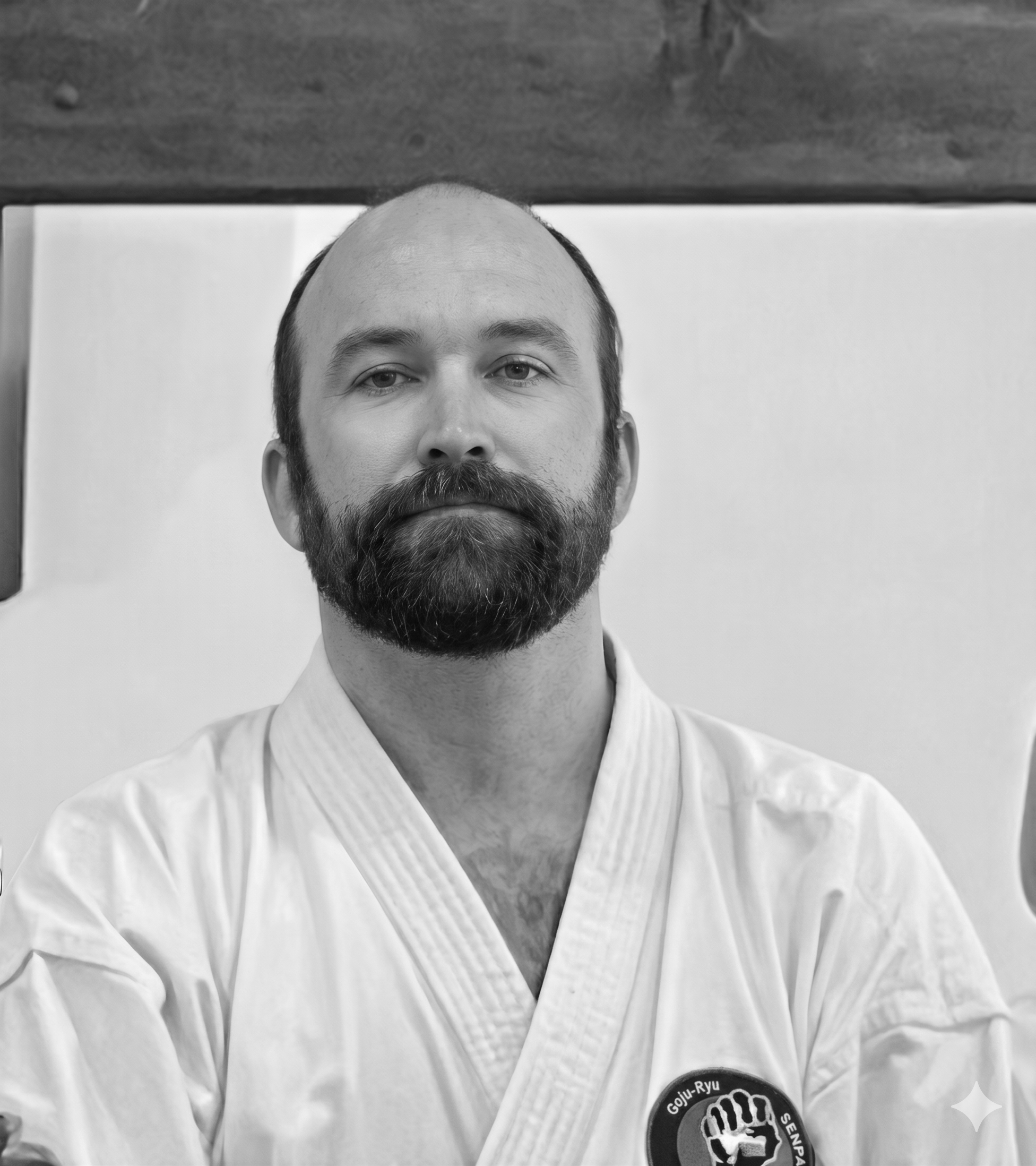Senpai Conrad Williams, 3rd Dan Black Belt, demonstrating precise movement and adult warm-ups for traditional Goju-Ryu karate classes.